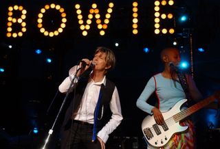 David Bowie (left) and Gail Ann Dorsey perform at the Jones Beach Theater on Long Island in 2002