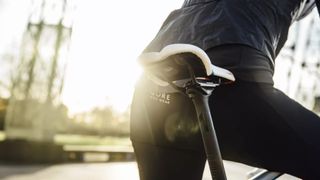 Woman standing near to a saddle