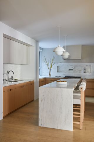 a white oak kitchen with a marble island