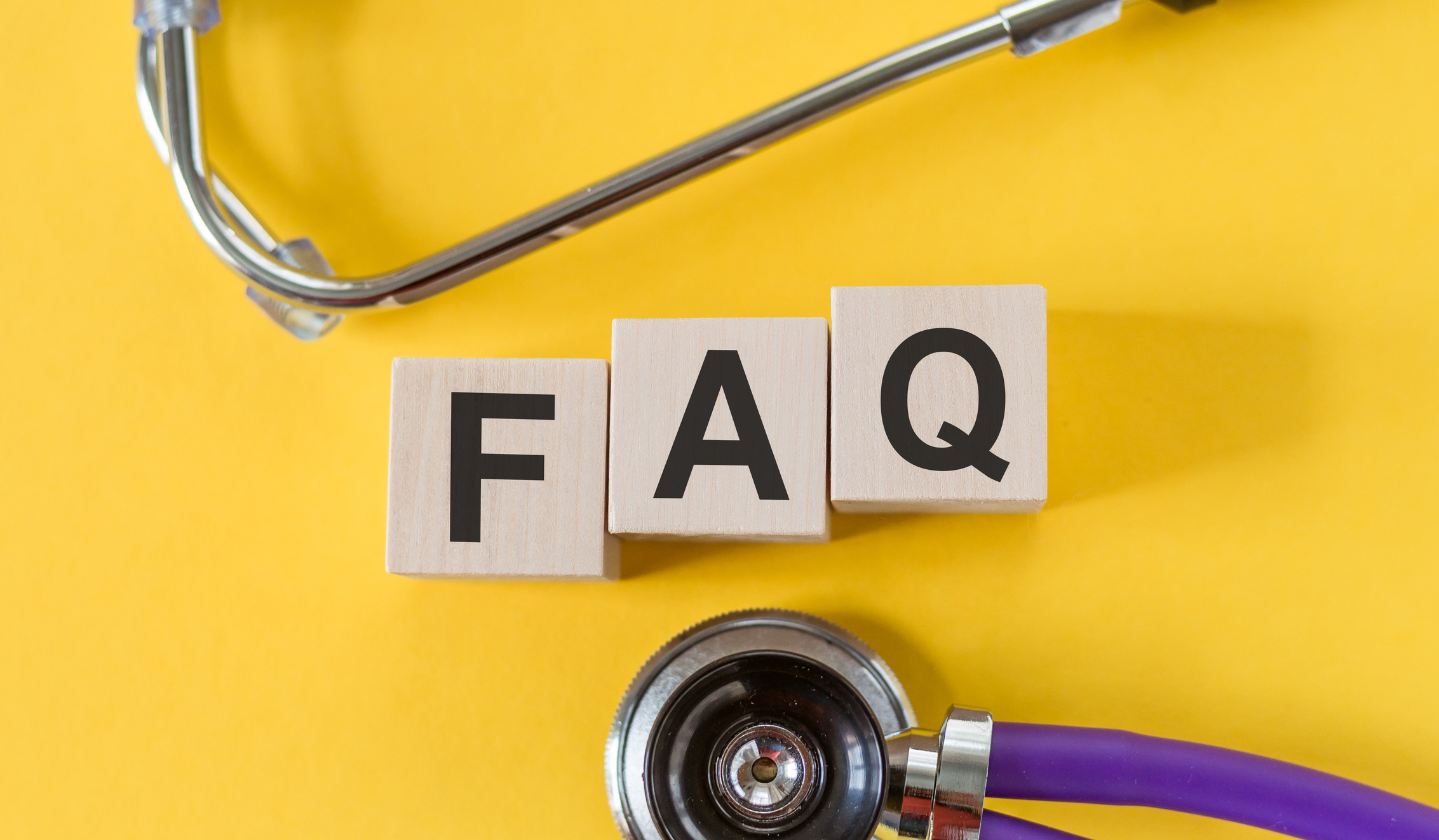 FAQ word made on building blocks, medical concept background.