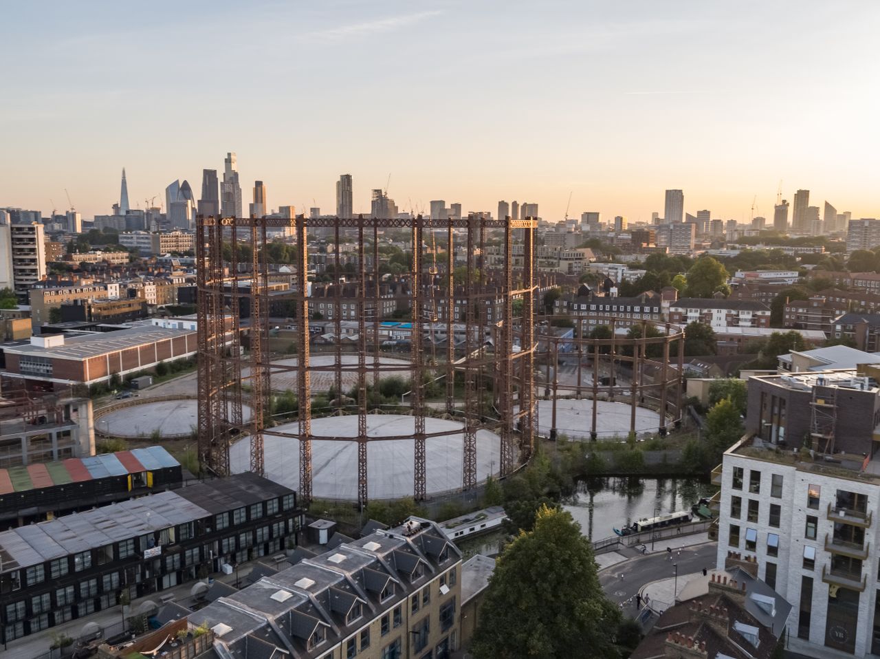 regent&#039;s view gasholders vista as they were before, disused in their industrial state across the east london cityscape