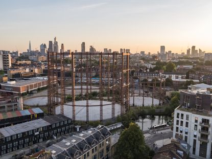 regent&#039;s view gasholders vista as they were before, disused in their industrial state across the east london cityscape