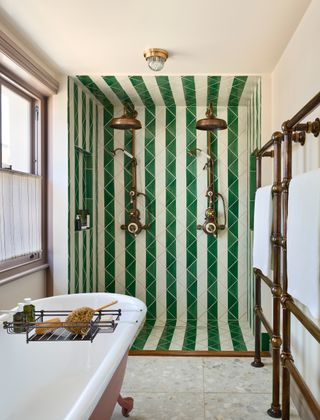 a green striped tiled shower in a bathroom