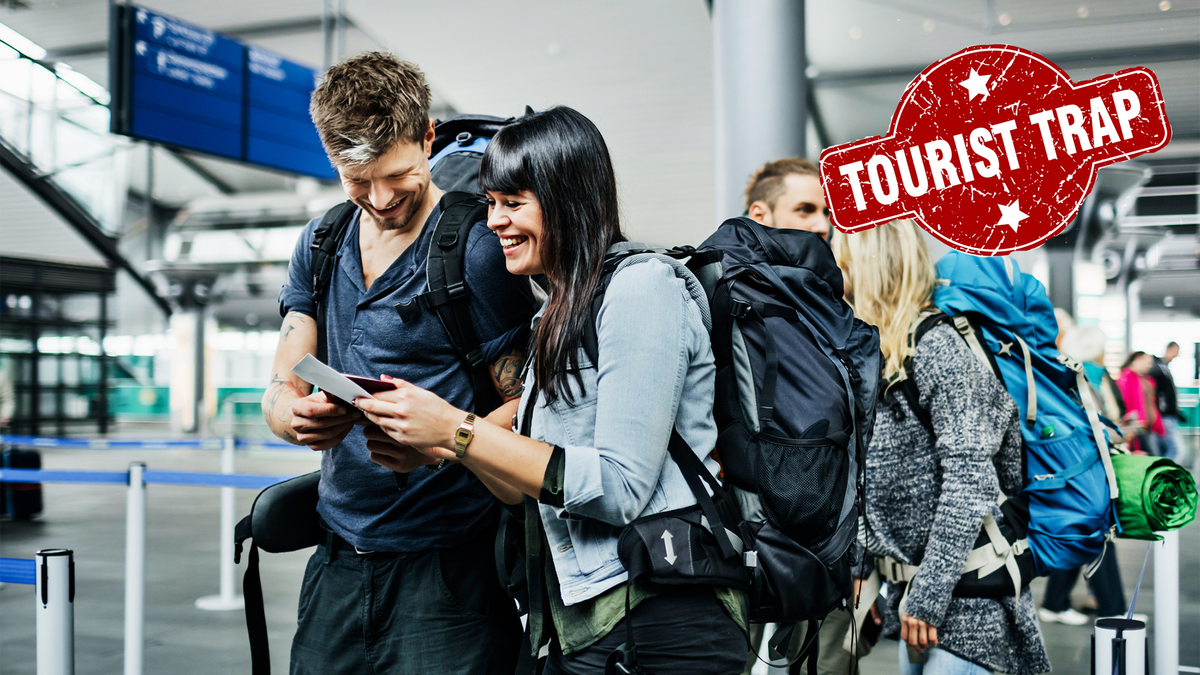 Group of tourists at an airport with &quot;tourist trap&quot; stamped in the corner