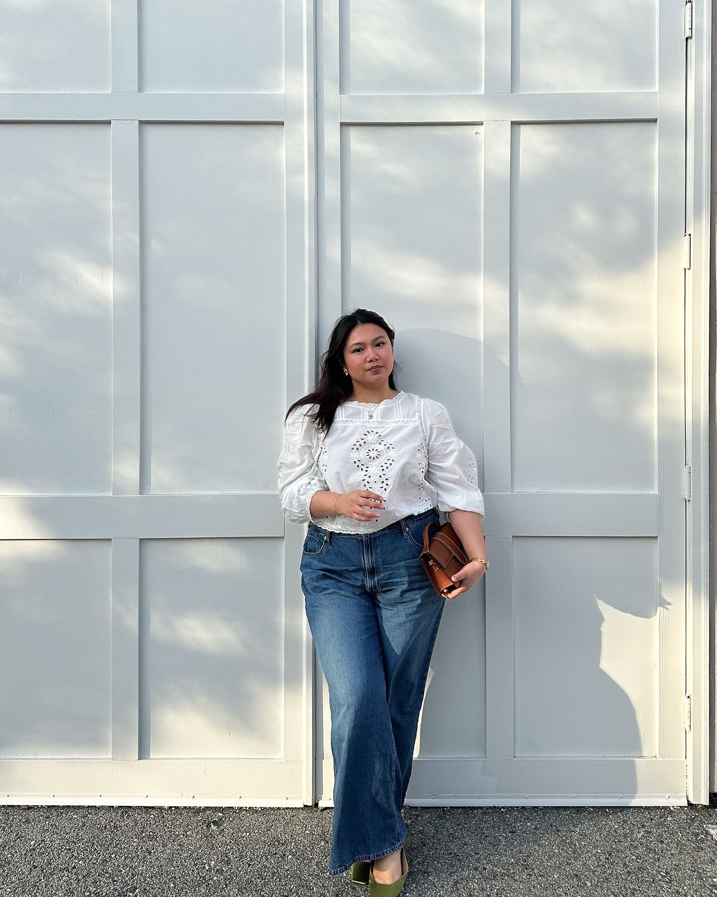Woman wears pretty summer blouse with jeans