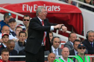 Manchester United manager Sir Alex Ferguson points at his watch during the Premier League match against Arsenal at the Emirates Stadium, May 2011