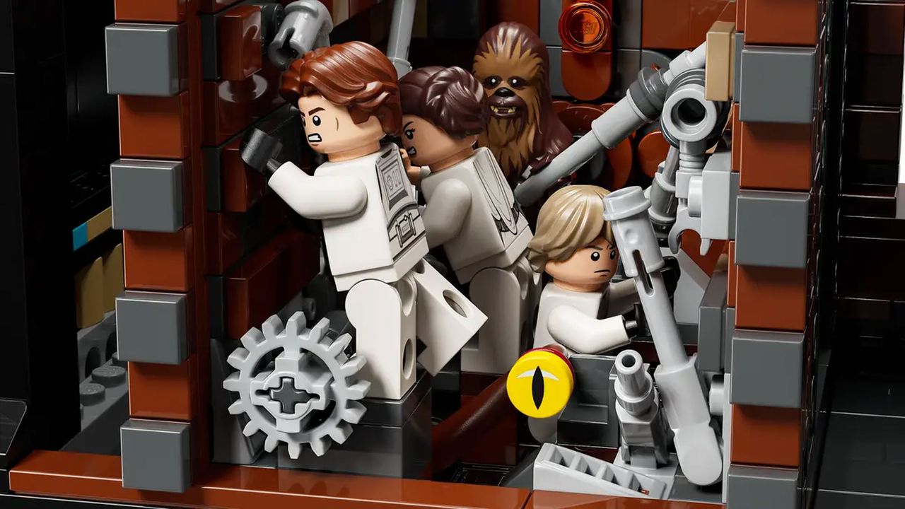 The interior of a circular space station with several floors and rooms filled with minifigures shows the minifigures posed in action.