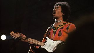 Jimi Hendrix (1942-1970) performs live on stage playing a black Fender Stratocaster guitar at the 1970 Isle of Wight Festival at Afton Down on the Isle of Wight on the night of 30th-31st August 1970.