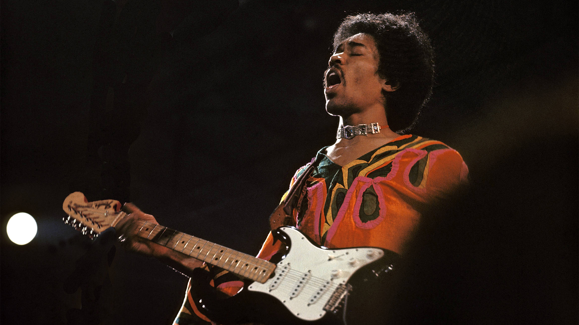 Jimi Hendrix (1942-1970) performs live on stage playing a black Fender Stratocaster guitar at the 1970 Isle of Wight Festival at Afton Down on the Isle of Wight on the night of 30th-31st August 1970. 