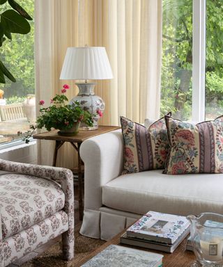 vintage style living room with conservatory and patterned cushions and accent chair