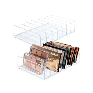 Two acrylic eyeshadow holders with eyeshadow palettes in them
