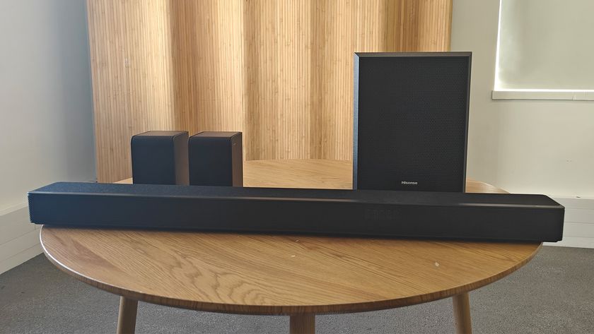 The Hisense AX5125H Dolby Atmos soundbar system, pictured on a round, wooden table