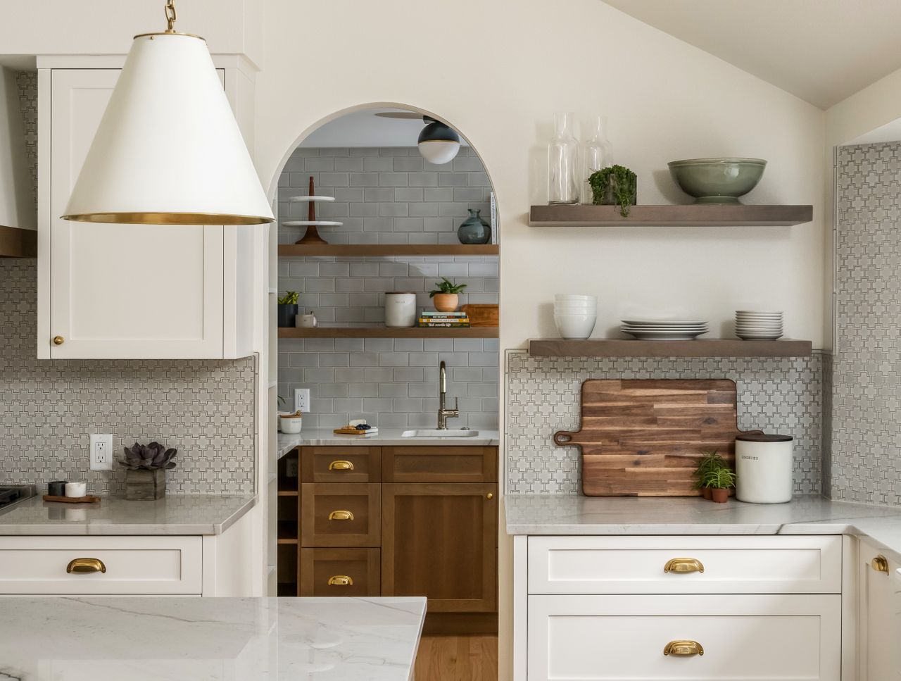 A kitchen with a butlers pantry located behind