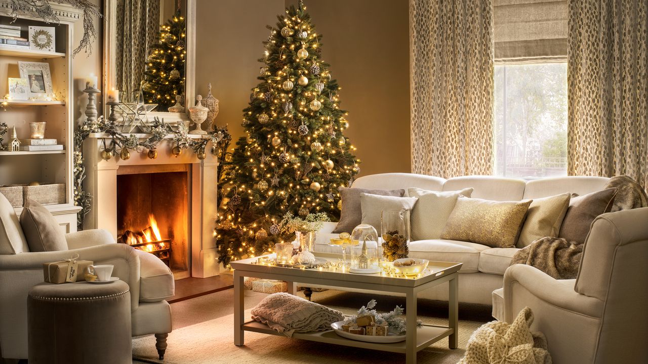 Cosy Christmas living room with cream corner sofa, christmas tree and glowing fireplace