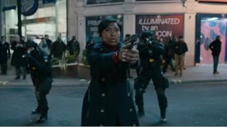 Cynthia Erivo aims her gun in an attempt to make an arrest in Piccadilly Circus in Luther: The Fallen Sun.