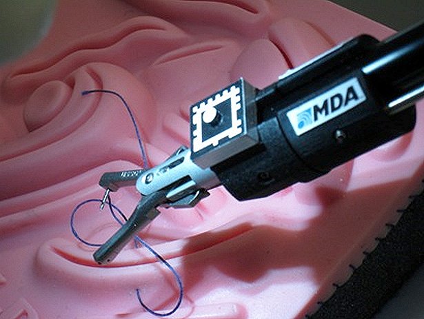 Close-up of the suturing tool on KidsArm doing simulated image-guided anastomosis (connecting parts such as vessels).