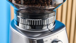 the breville dose control pro, called sage dose control pro in the uk, a silver coffee grinder with 60 grind settings and labeled grind size adjustment