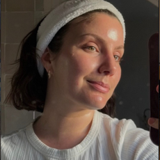 @emmahoareau with glowing skin wearing a headband and taking a picture in a mirror
