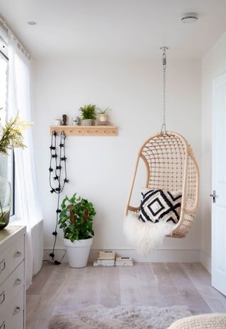 Hanging chair in the corner of a bedroom