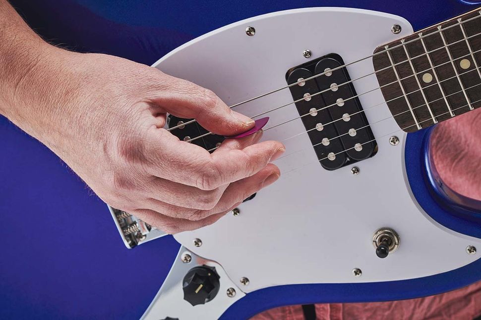 How to hold a guitar and a guitar pick Guitar World