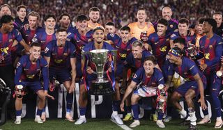 Ronald Araujo of FC Barcelona celebrates with the La Liga trophy with teammates after the match against Real Madrid C.F. at Spotify Camp Nou stadium on May 10, 2026 in Barcelona, Spain