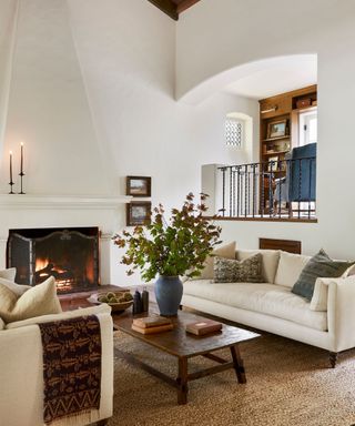 living room with gallery and railings fire lit