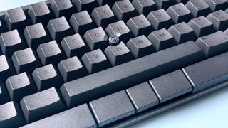 The HHKB Studio mechanical keyboard against a blue background.