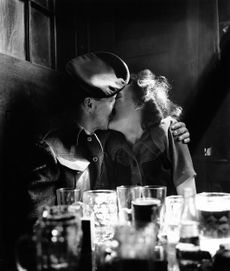 A soldier kissing a young woman in a pub during V-E Day celebrations in London, 8th May 1945. (Photo by Paul Popper/Popperfoto via Getty Images/Getty Images)