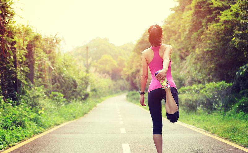 A woman stretches before a run.