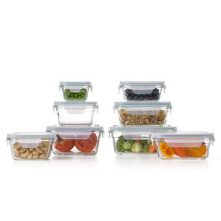 glass food prep containers full of vegetables, tomatoes, nuts, peas, blueberries 