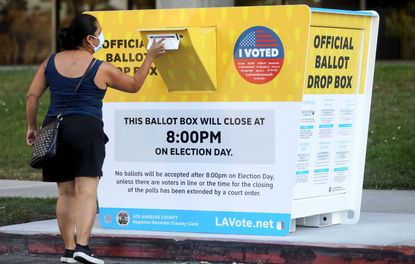 A woman drops off her ballot in Los Angeles County.