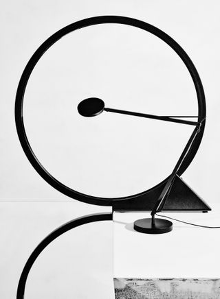 Black and white photograph of two table lamps by Artemide and Tobias Grau