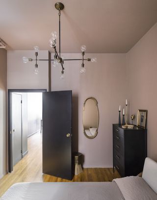 colors that go with black with a pink painted room with black doors and a black dresser
