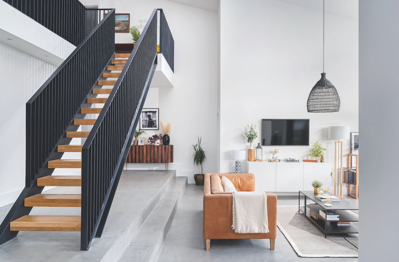 living room with open steel and wood staircase