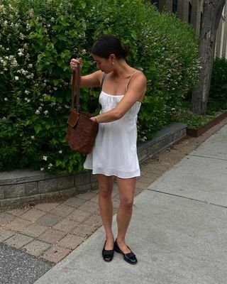 @sasha.mei wearing a white dress with ballet flats