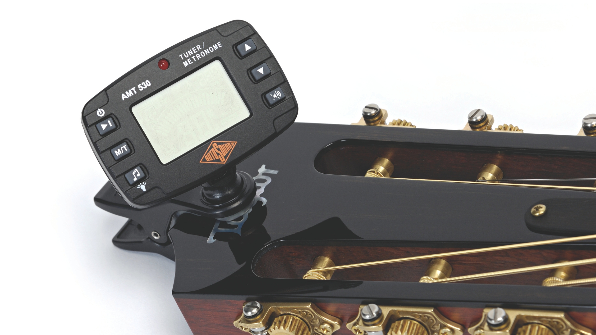 A Rotosound clip on guitar tuner on a classical acoustic guitar