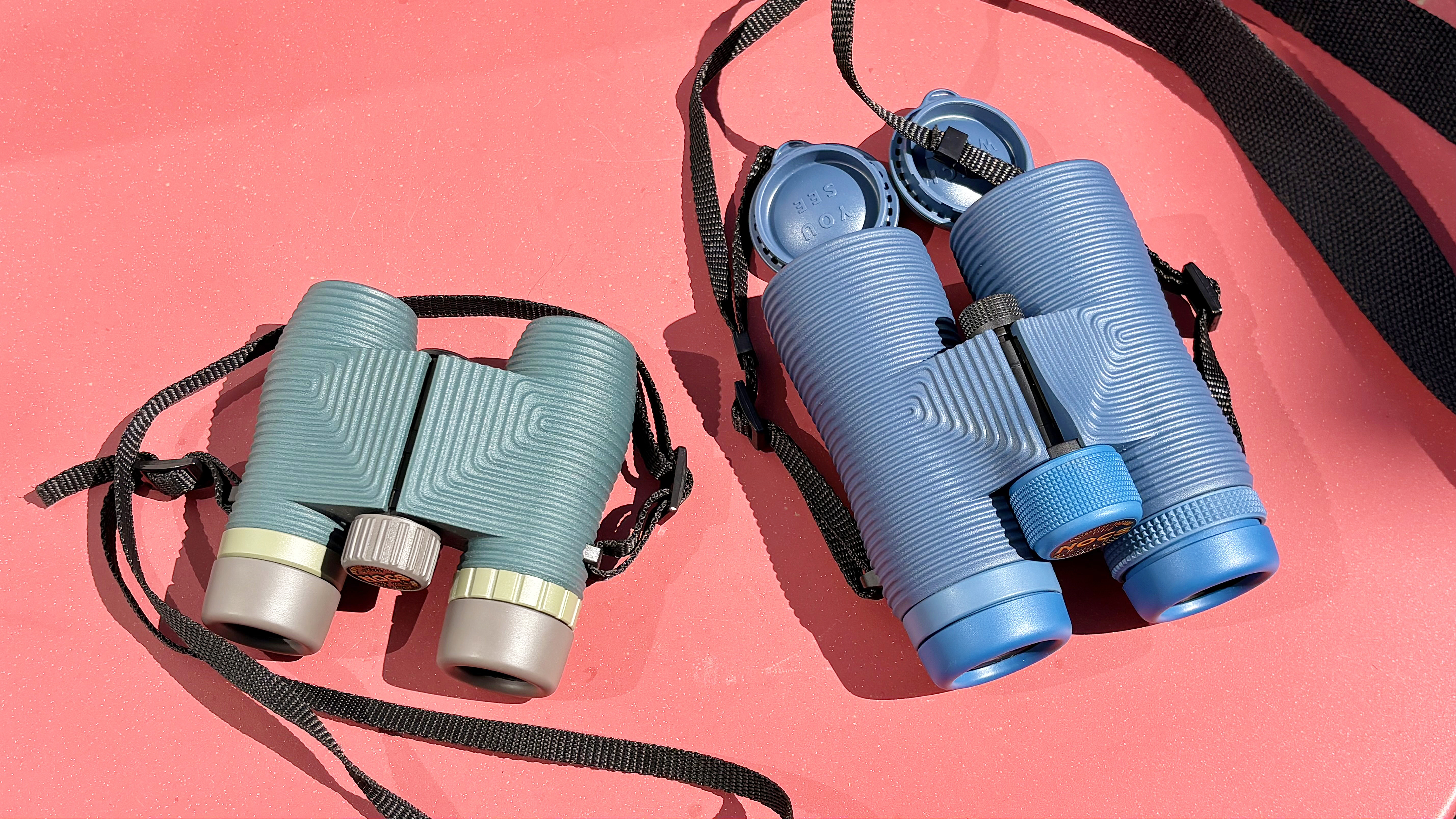 Close-up of the Nocs Standard Issue 8x25 binoculars next to the new Nocs Field Issue 42 binoculars