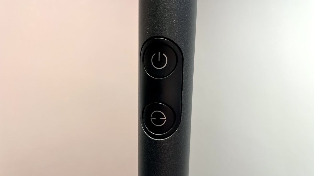 A close-up of the two buttons on the pole of the Govee Uplighter Floor Lamp.