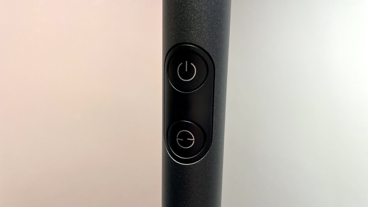 A close-up of the two buttons on the pole of the Govee Uplighter Floor Lamp.