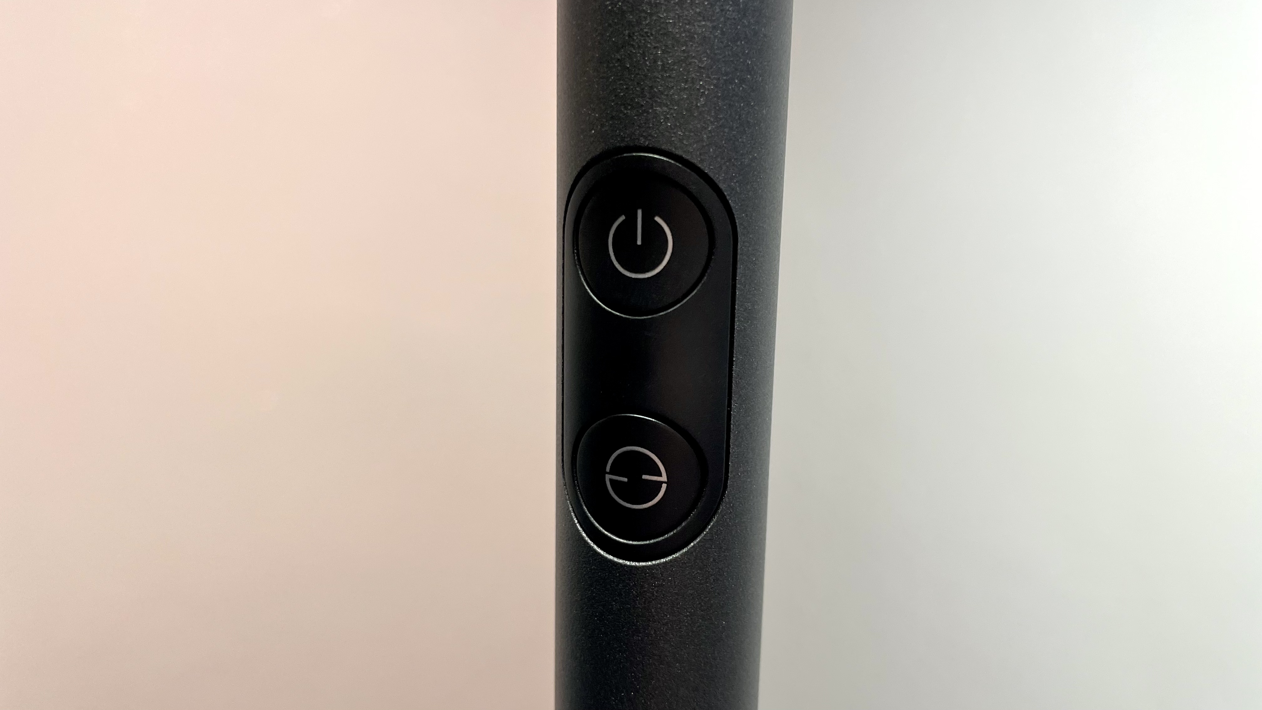 A close-up of the two buttons on the pole of the Govee Uplighter Floor Lamp.
