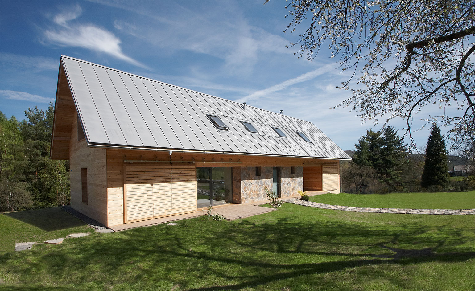 Exterior of house with wood and stone and glazed strips