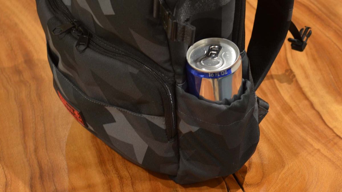 A Hex Technical Backpack on a wood grain table