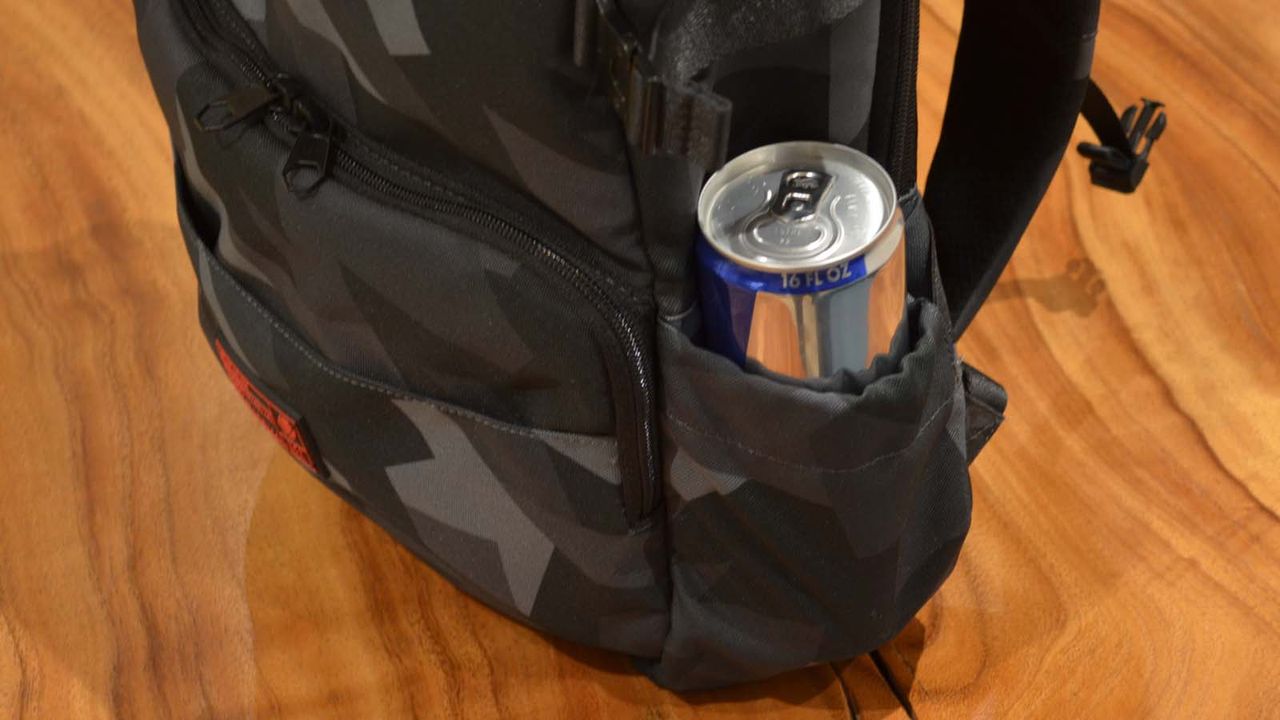A Hex Technical Backpack on a wood grain table