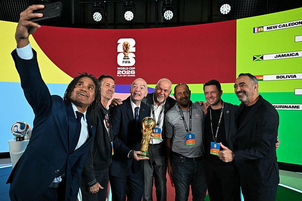 French former player Christian Karembeu takes a selfie with (from 3L) FIFA President Gianni Infantino, President of the Caledonian Football Federation Gilles Tavergeux, member of the Caledonian Football Federation Patrice Mandaoue, New Caledonia's coach Johann Sidaner and former French football player Youri Djorkaeff following the 2026 FIFA World Cup European Play-Off draw at the FIFA's Home of Football in Zurich on November 20, 2025. (Photo by Fabrice COFFRINI / AFP)