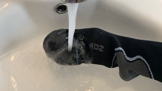 EDZ waterproof socks being tested under a tap