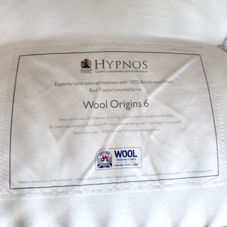 The Hypnos Wool Origins 6 mattress being tested in a bedroom with a wooden bedframe