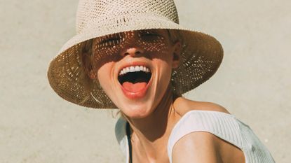 a woman laughing - best face tan