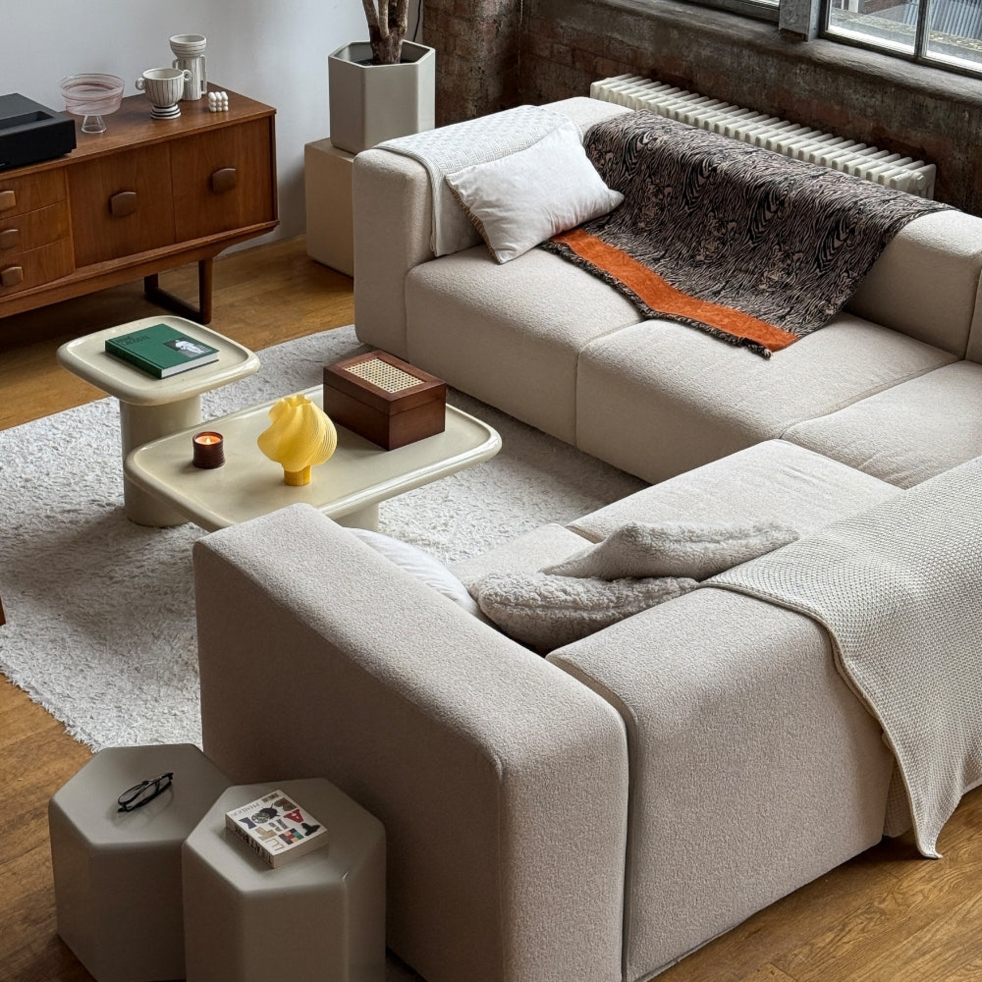 The Sazy Cob modular corner sofa in cream boucle in a midcentury modern-style living room