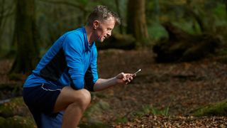 Male runner using route planning app