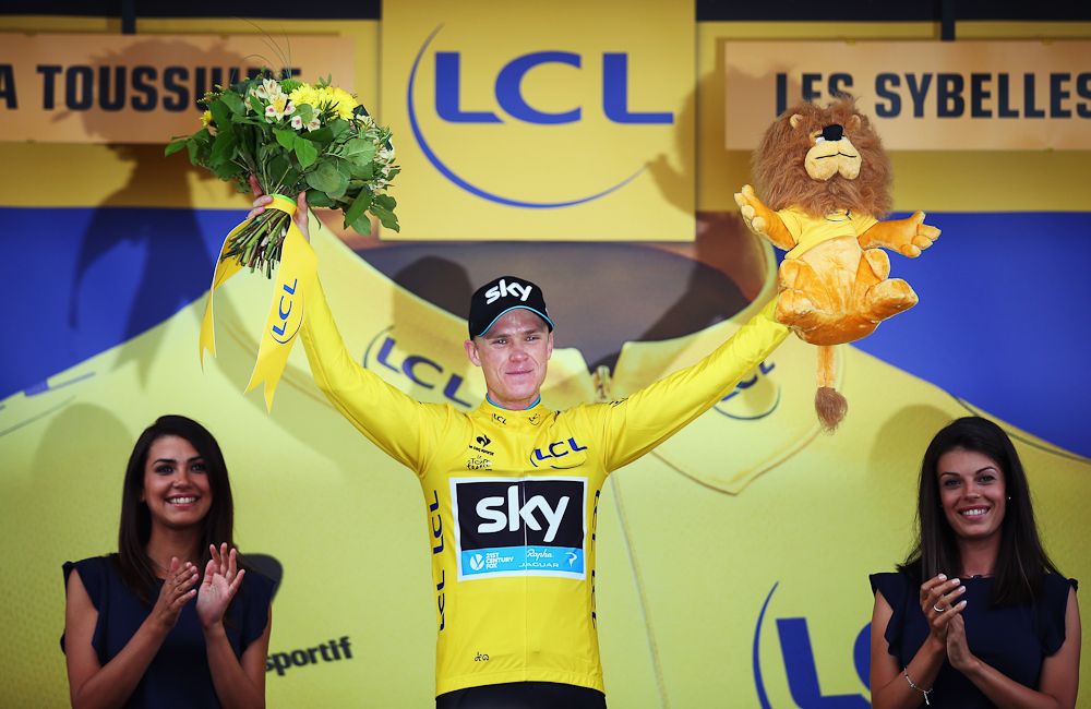 Chris Froome in yellow on the stage 19 podium.
